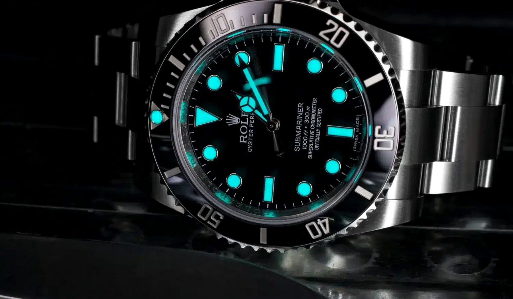 Luxury dive watch with luminous markers glowing on a black dial