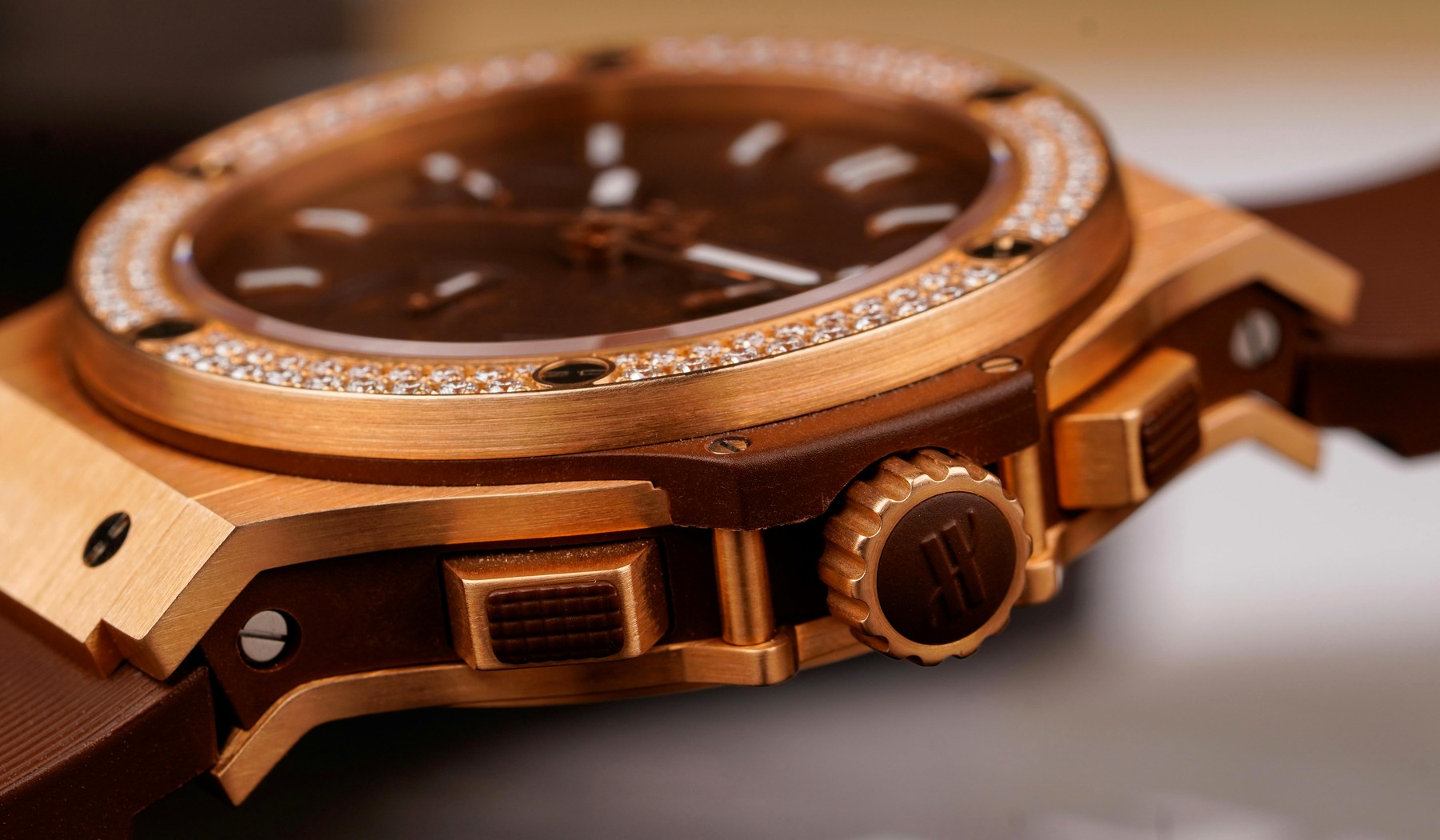 Rose gold luxury watch close-up showing warm gold-tone case finishing