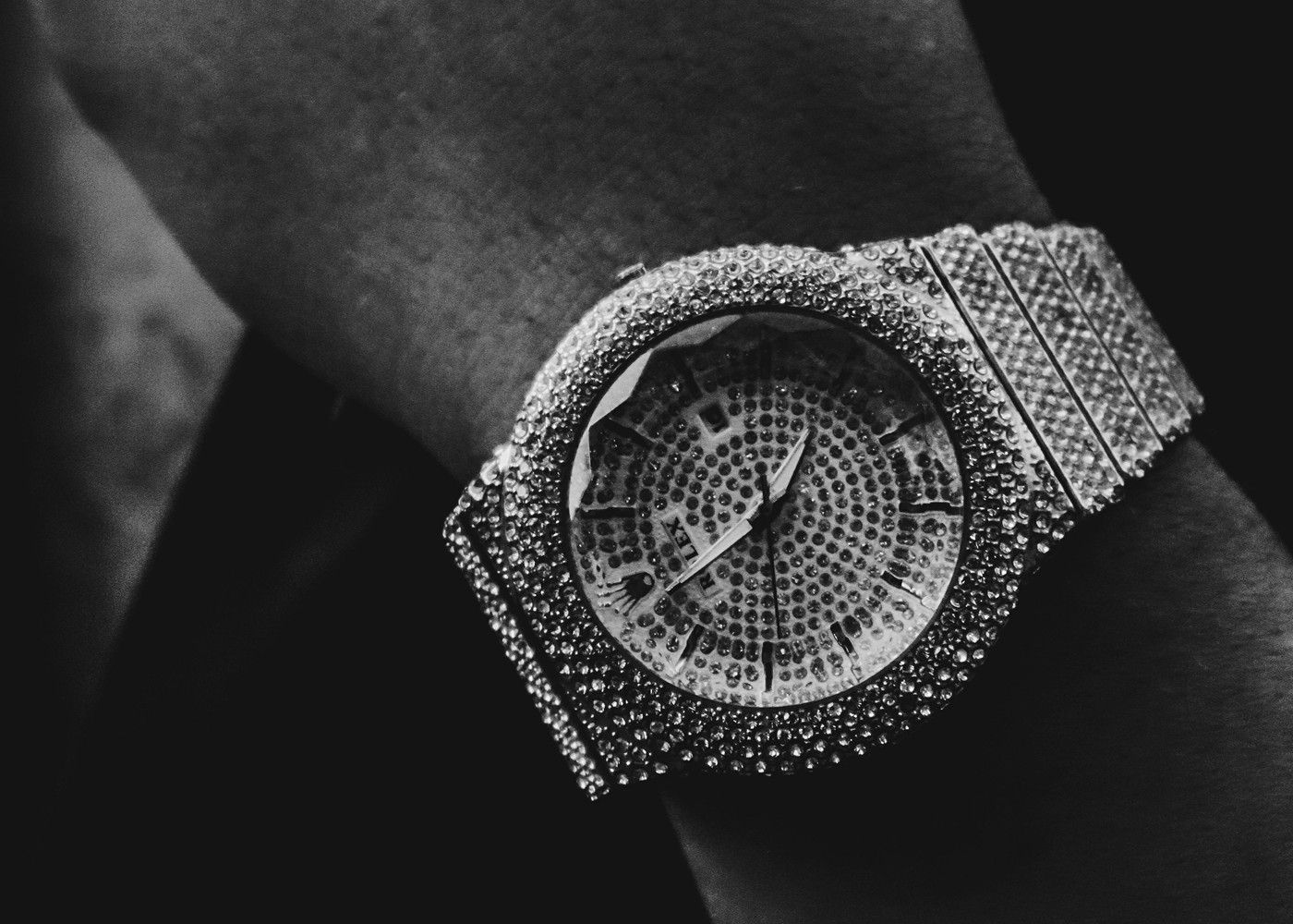 Black and white close-up of diamond-set watch stone rows and bezel setting