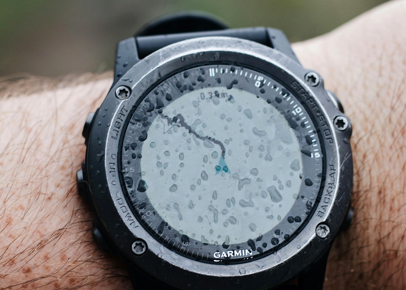 Wristwatch with water droplets on the crystal during rain exposure